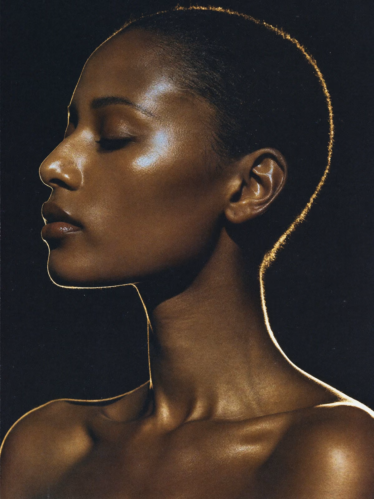 Editorial study of luminous skin traced by champagne-gold light, the standard of care aesthetic clinics sell, and the standard we build to.